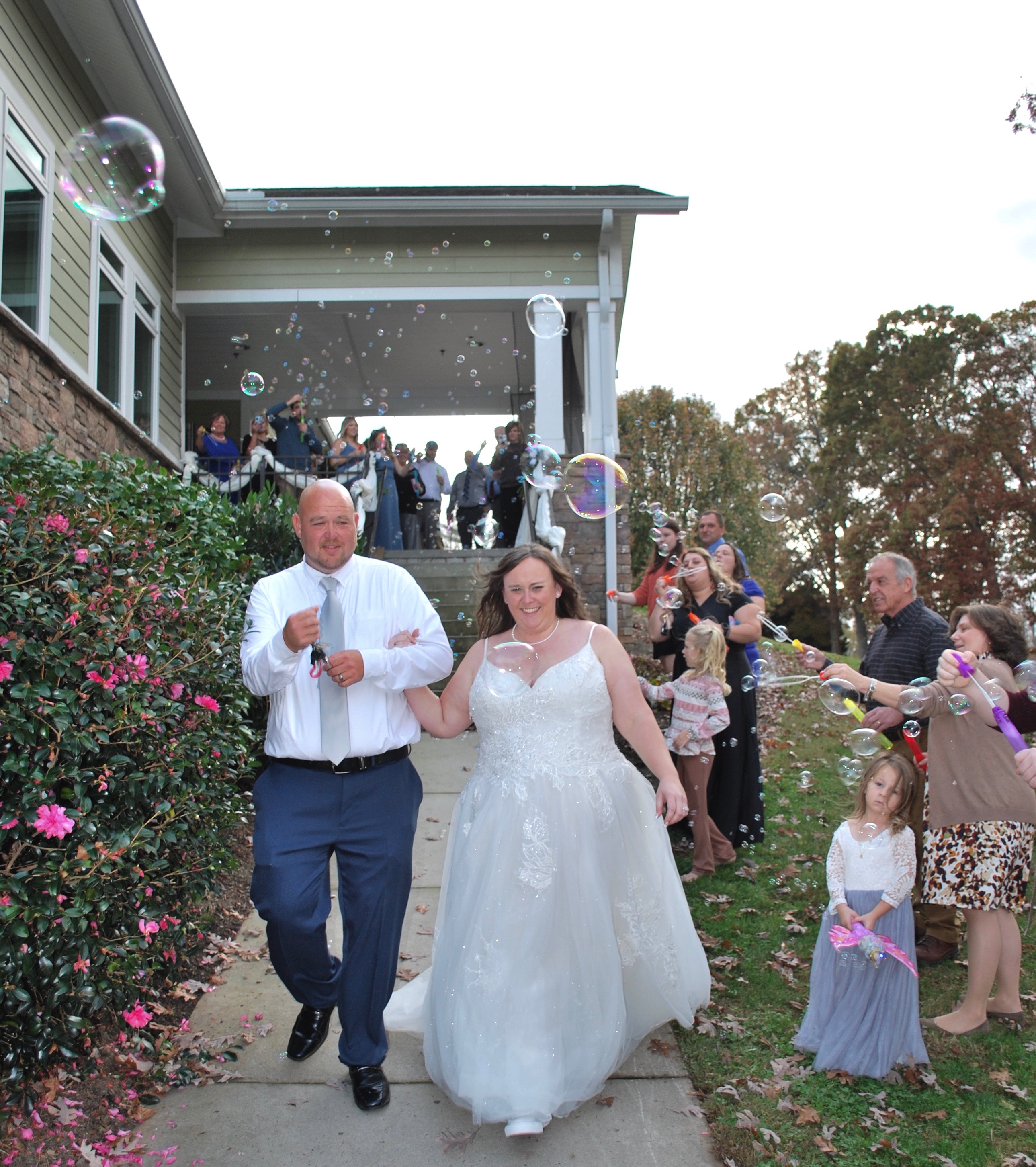 The bride and groom walking outside